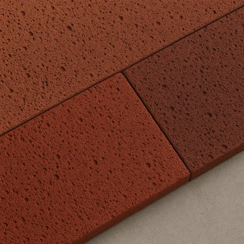 Lava stone merah untuk aksen fasad dan pagar signature